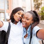 heureux-amis-de-collège-africain-prenant-selfie-ensemble